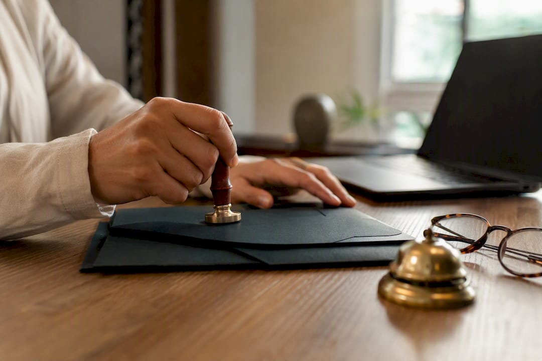 Notary placing seal on document folder