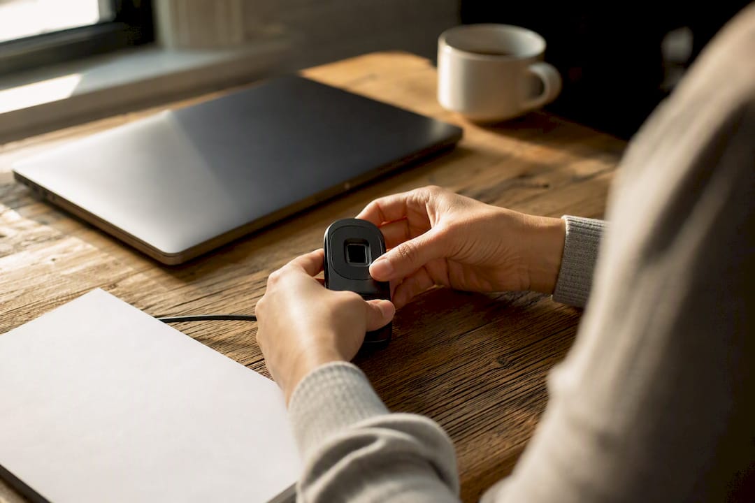 Hands holding biometric device preparing notarization